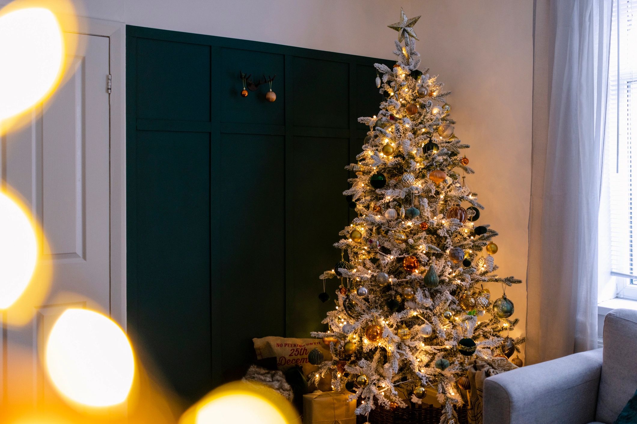 Decorated Christmas tree glowing in a cozy living room