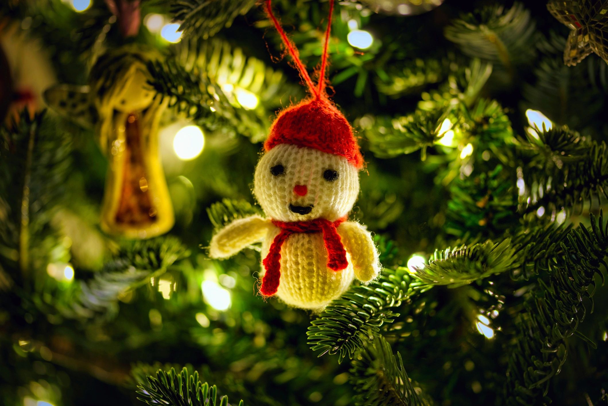 Knitted snowman ornament on a Christmas tree